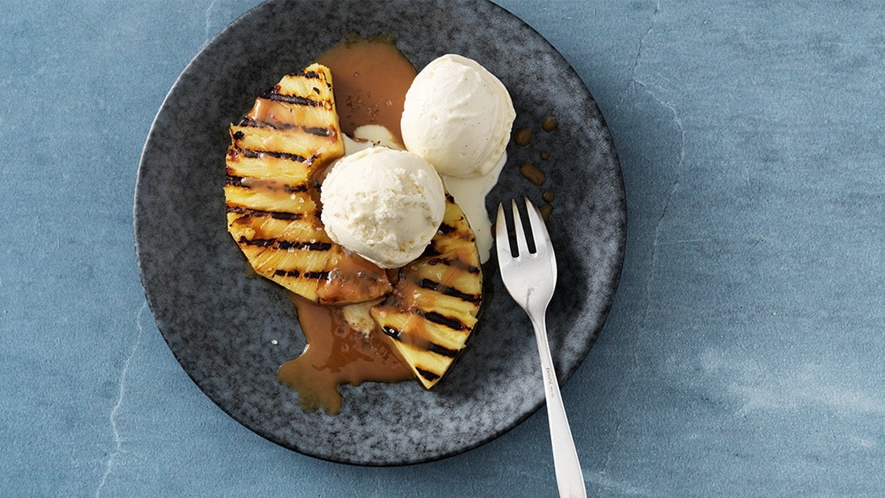 Gegrillte Ananas mit Vanilleeis und Karamellsauce.