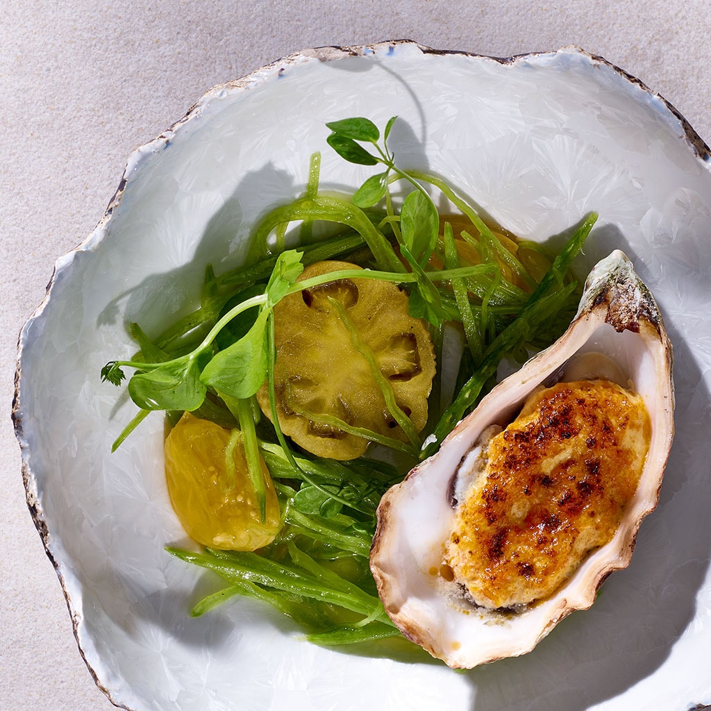 Gratinierte Felsenauster mit Shichimi-Hollandaise und kleinen Salat von gerösteten Tomatillo und Erbsen